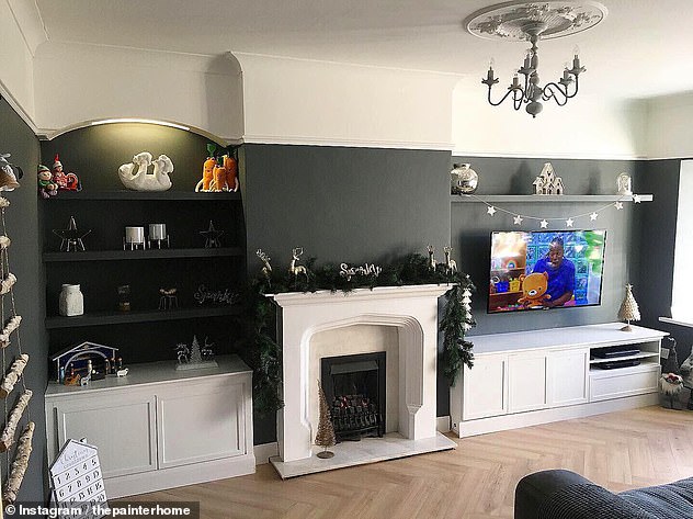 The couple transformed the living room with new flooring, a coat of chic dark grey paint and new shelving